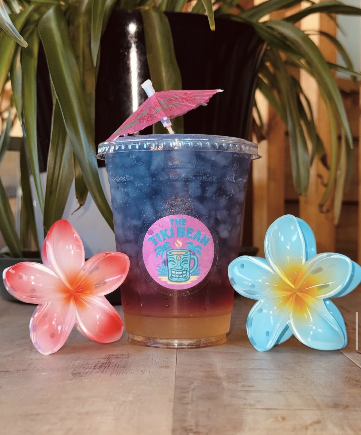 Blue butterfly-pea sunset refresher with a pink cocktail umbrella